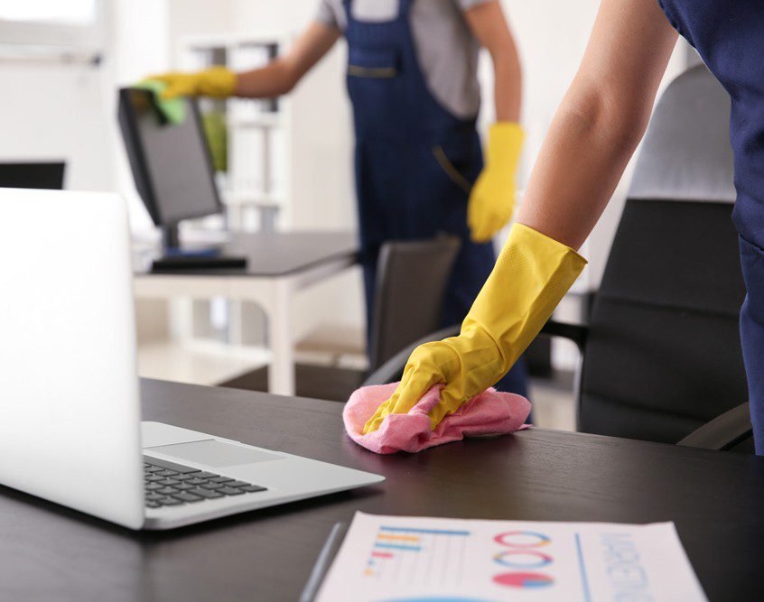 Janitor wiping table in office Office Cleaning Service in Australia